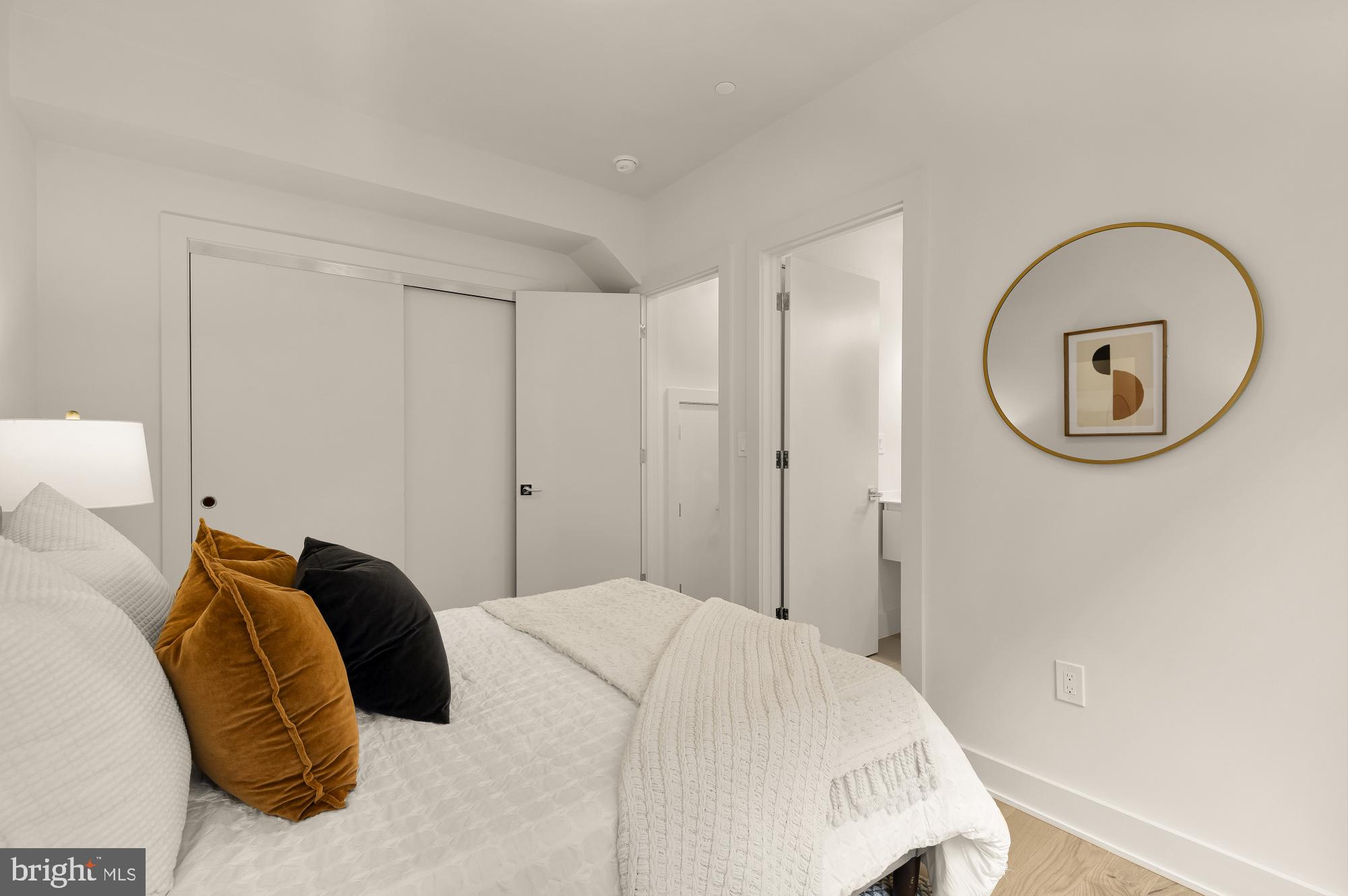 2647 41st Street Northwest, Unit 1 Washington, DC 20007 - Photo 26 of 32 a bedroom with a bed and a mirror