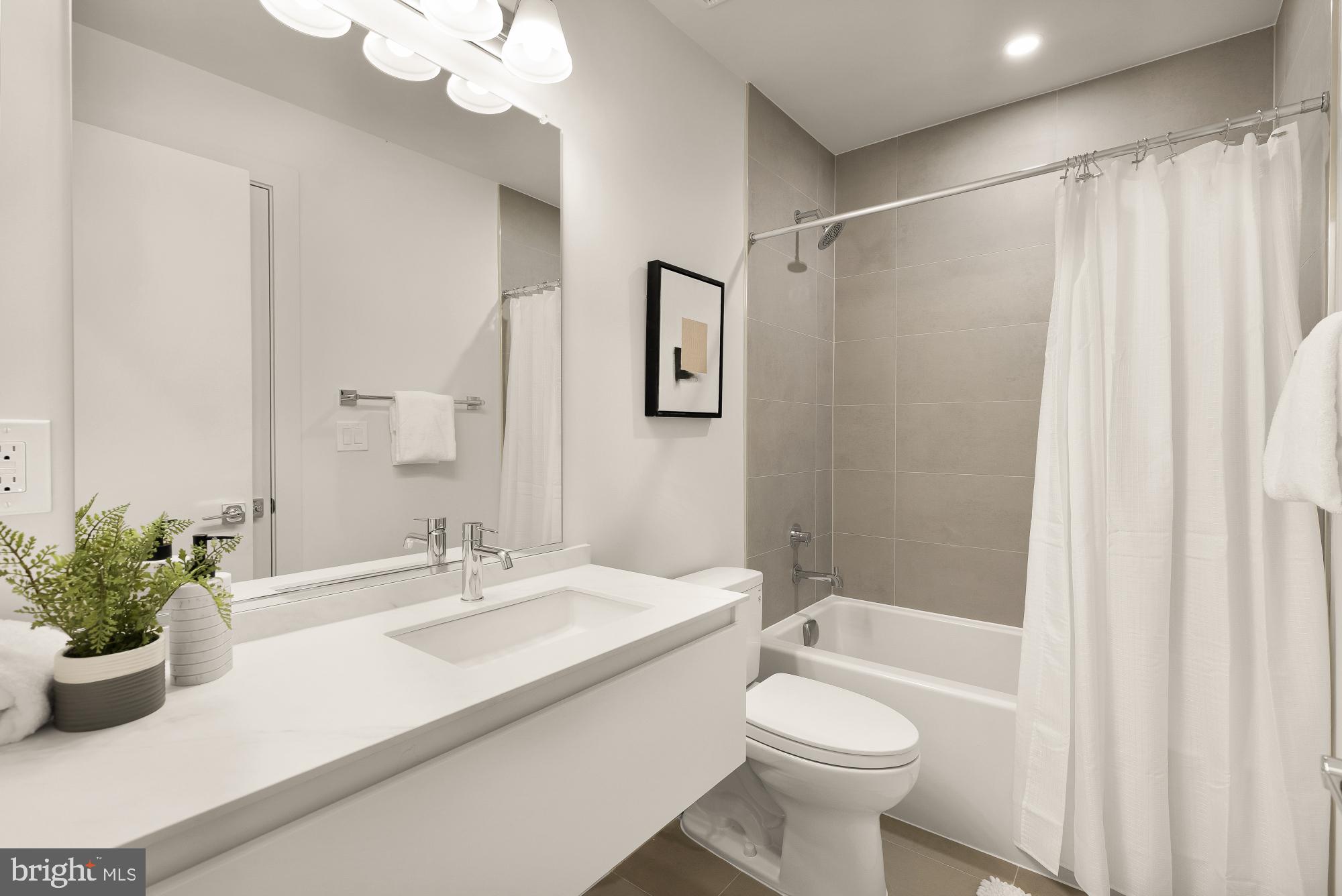 2647 41st Street Northwest, Unit 1 Washington, DC 20007 - Photo 29 of 32 a bathroom with a sink a toilet and shower