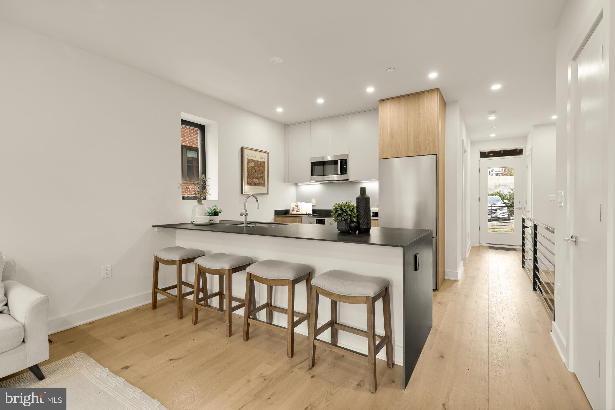 2647 41st Street Northwest, Unit 1 Washington, DC 20007 - Photo 5 of 32 a kitchen with stainless steel appliances granite countertop a refrigerator and a stove top oven