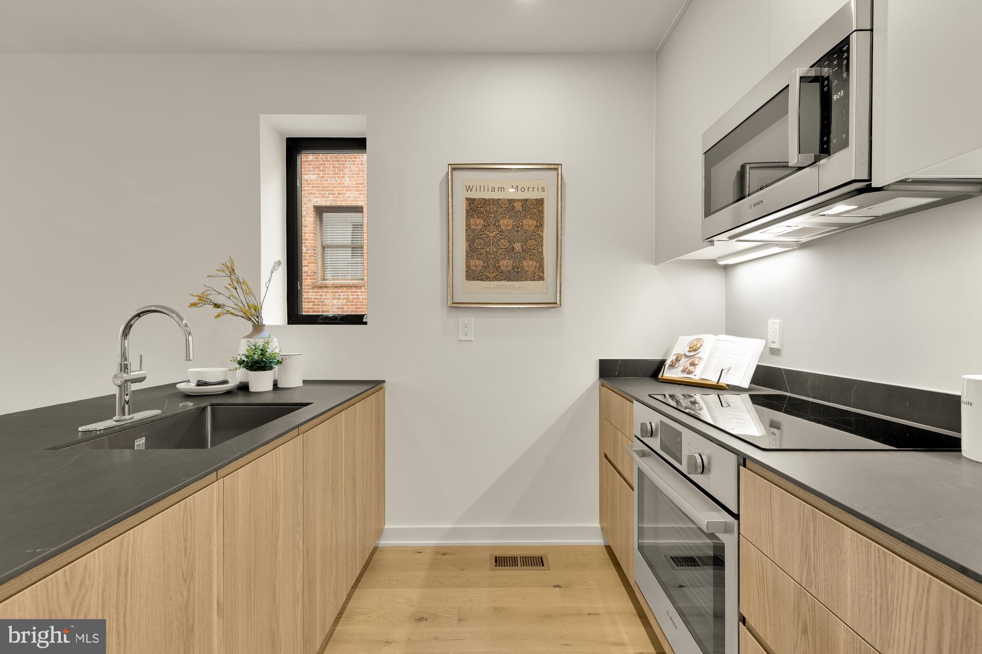 2647 41st Street Northwest, Unit 1 Washington, DC 20007 - Photo 8 of 32 a kitchen with stainless steel appliances granite countertop a sink and cabinets