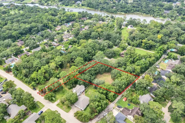 an aerial view of residential house with outdoor space and trees all around