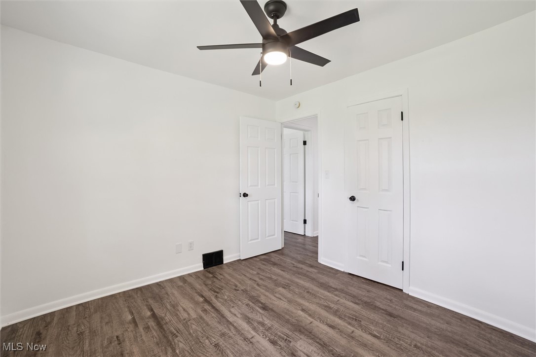 12241 Huffman Road Cleveland, OH 44130 - Photo 27 of 43 Unfurnished bedroom featuring dark wood-style floors and ceiling fan