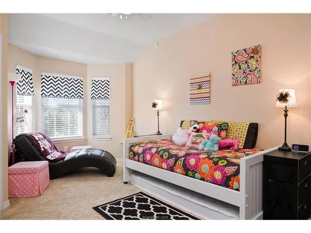 a bedroom with bed and a couch