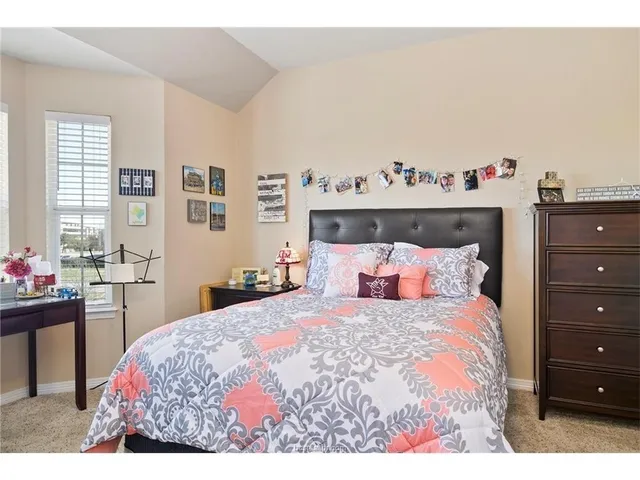 a bedroom with a bed and a table