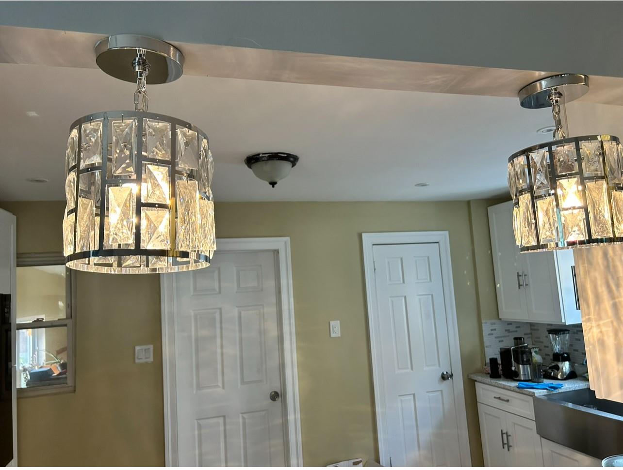 218-34 104th Avenue Queens, NY 11429 - Photo 11 of 27 Kitchen featuring decorative light fixtures, white cabinets, and decorative backsplash