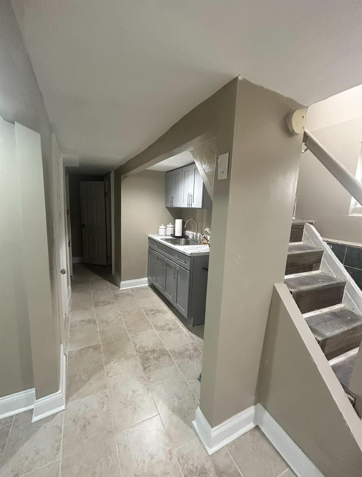 218-34 104th Avenue Queens, NY 11429 - Photo 13 of 27 Kitchen featuring gray cabinetry and sink