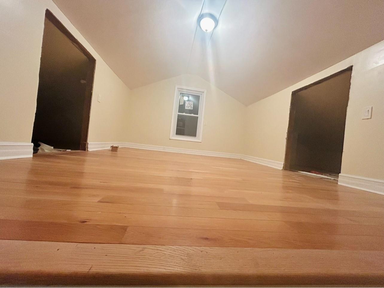 218-34 104th Avenue Queens, NY 11429 - Photo 17 of 27 Additional living space featuring hardwood / wood-style floors and vaulted ceiling