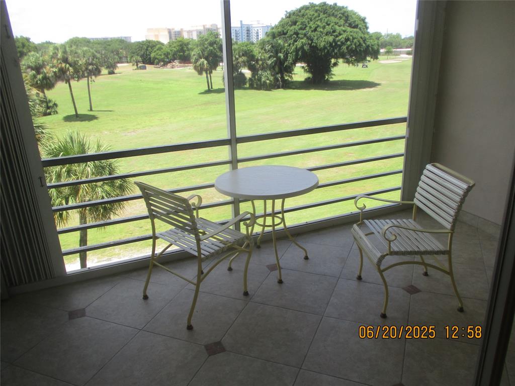 2651 South Course Drive, Unit 404 Pompano Beach, FL 33069 - Photo 11 of 40 a view of a outdoor space with seating area