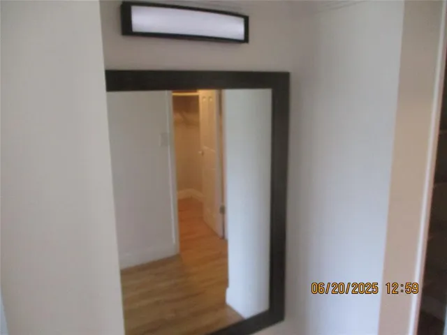 a view of a room with wooden floor