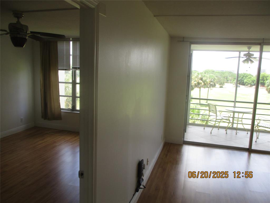 2651 South Course Drive, Unit 404 Pompano Beach, FL 33069 - Photo 2 of 40 an entryway with wooden floor and windows