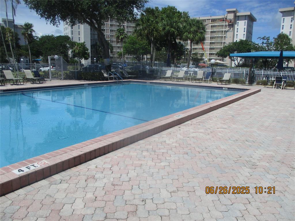 2651 South Course Drive, Unit 404 Pompano Beach, FL 33069 - Photo 39 of 40 a view of swimming pool with outdoor seating