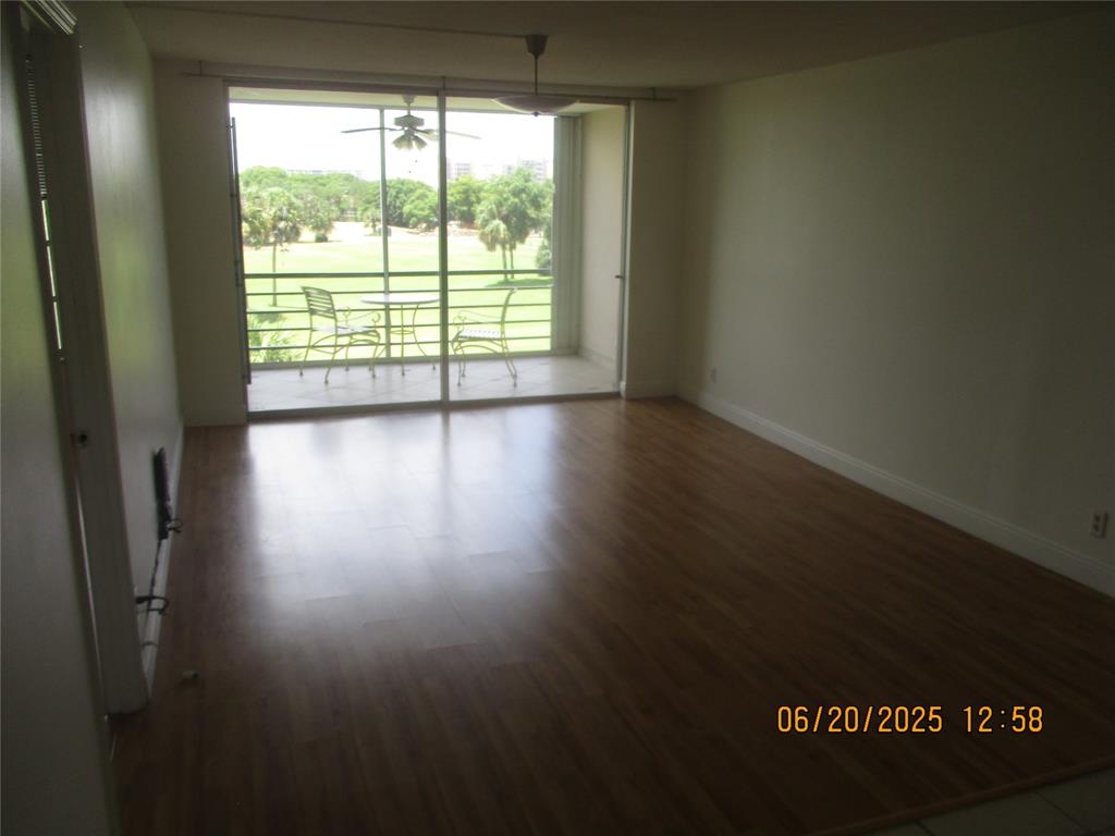2651 South Course Drive, Unit 404 Pompano Beach, FL 33069 - Photo 10 of 40 a view of wooden floor and windows in a room