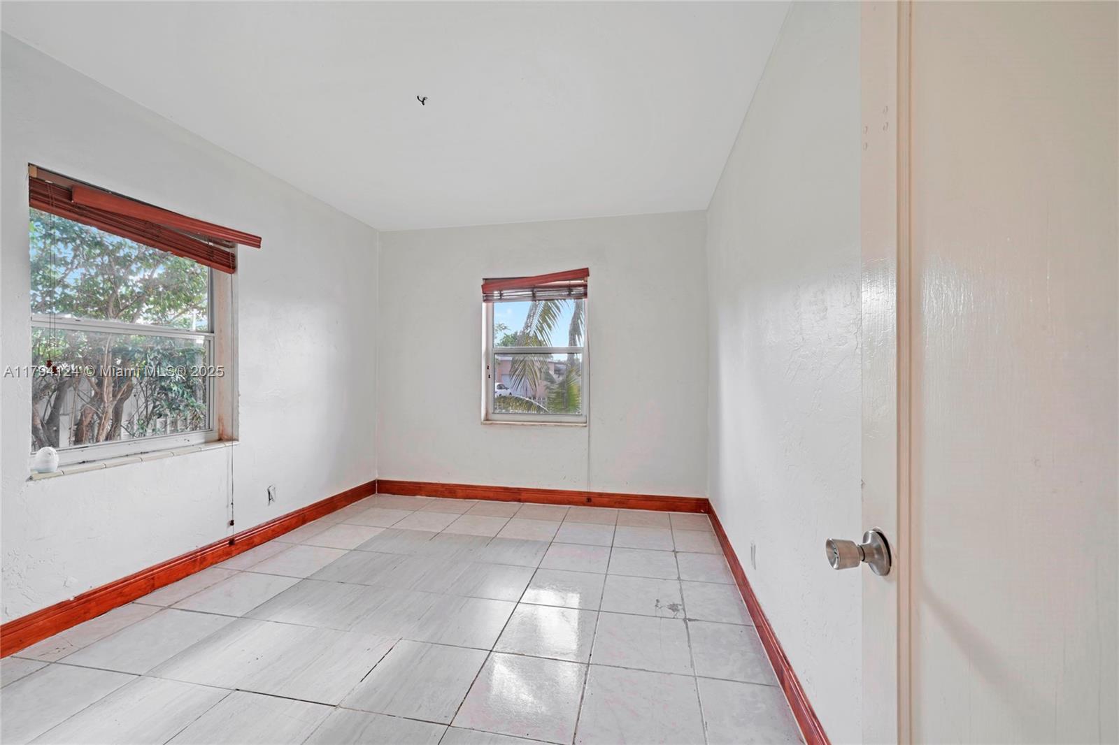 4241 West 1st Avenue Hialeah, FL 33012 - Photo 14 of 33 a view of an empty room with a window