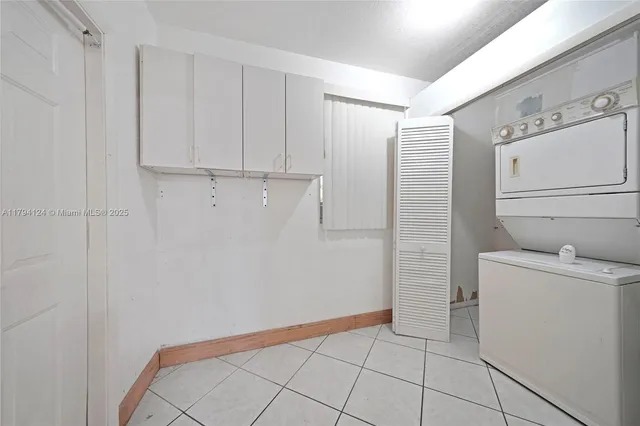 a hallway with a washer and dryer