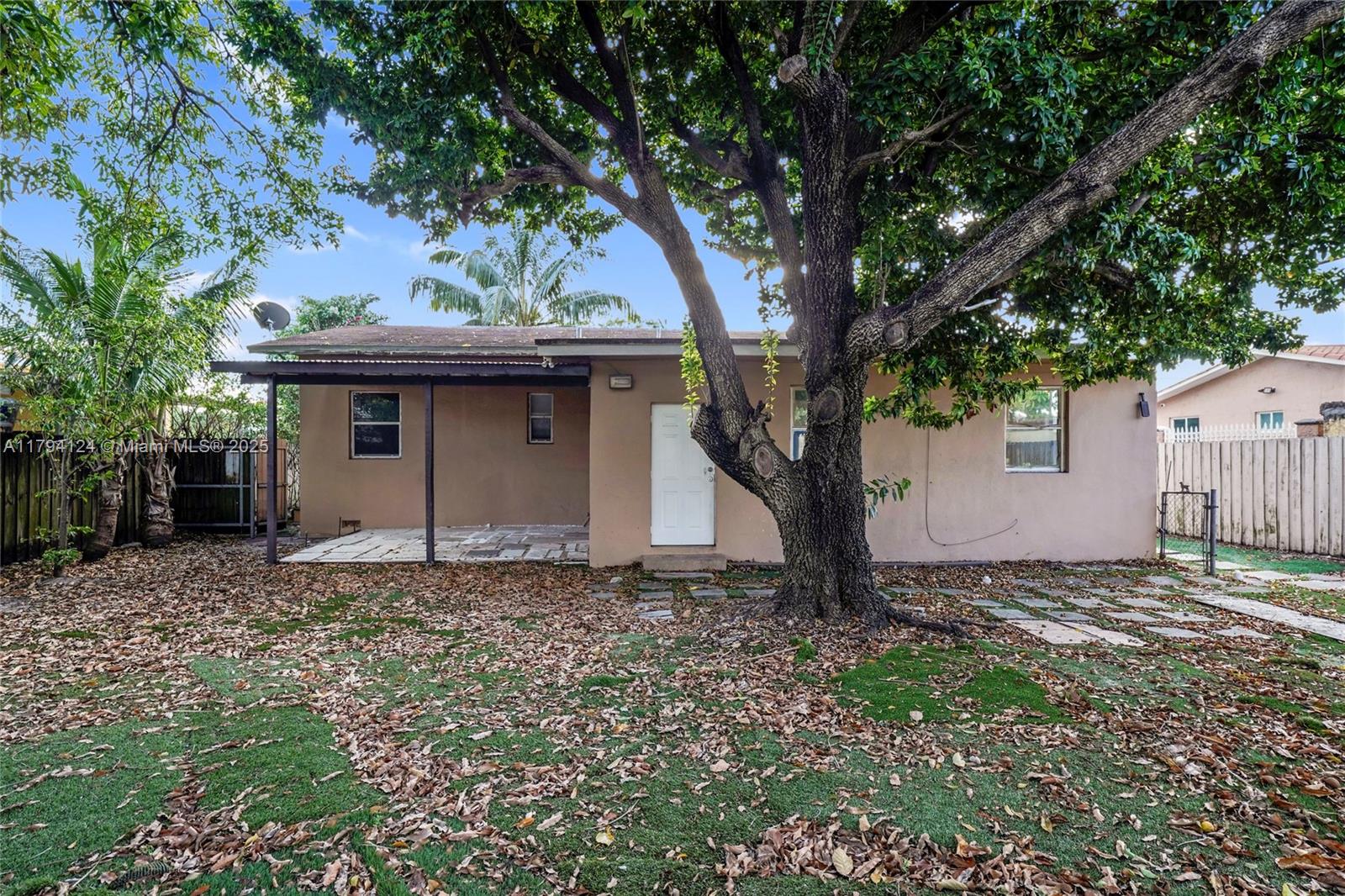 4241 West 1st Avenue Hialeah, FL 33012 - Photo 26 of 33 a house with trees in the background
