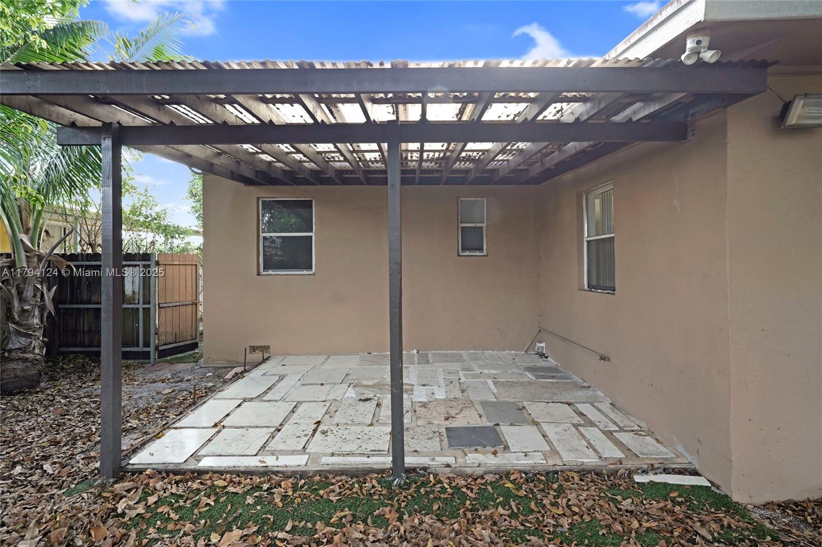 4241 West 1st Avenue Hialeah, FL 33012 - Photo 30 of 33 a backyard of a house with table and chairs