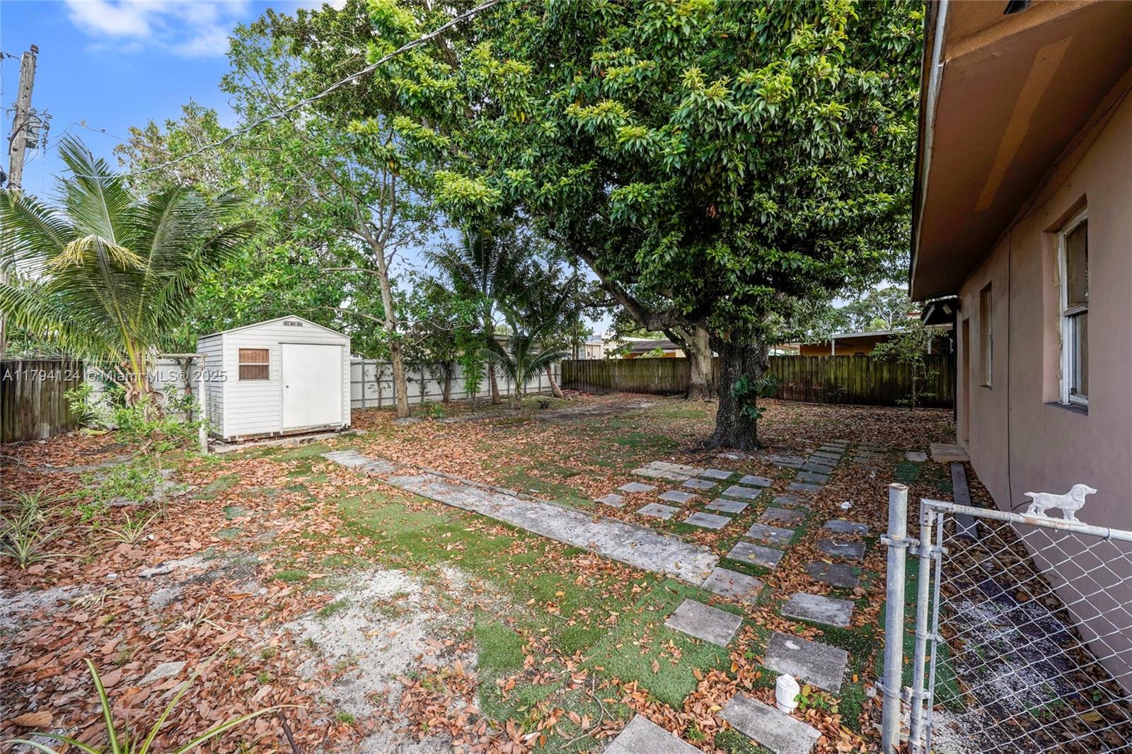 4241 West 1st Avenue Hialeah, FL 33012 - Photo 31 of 33 a backyard of a house with a tree