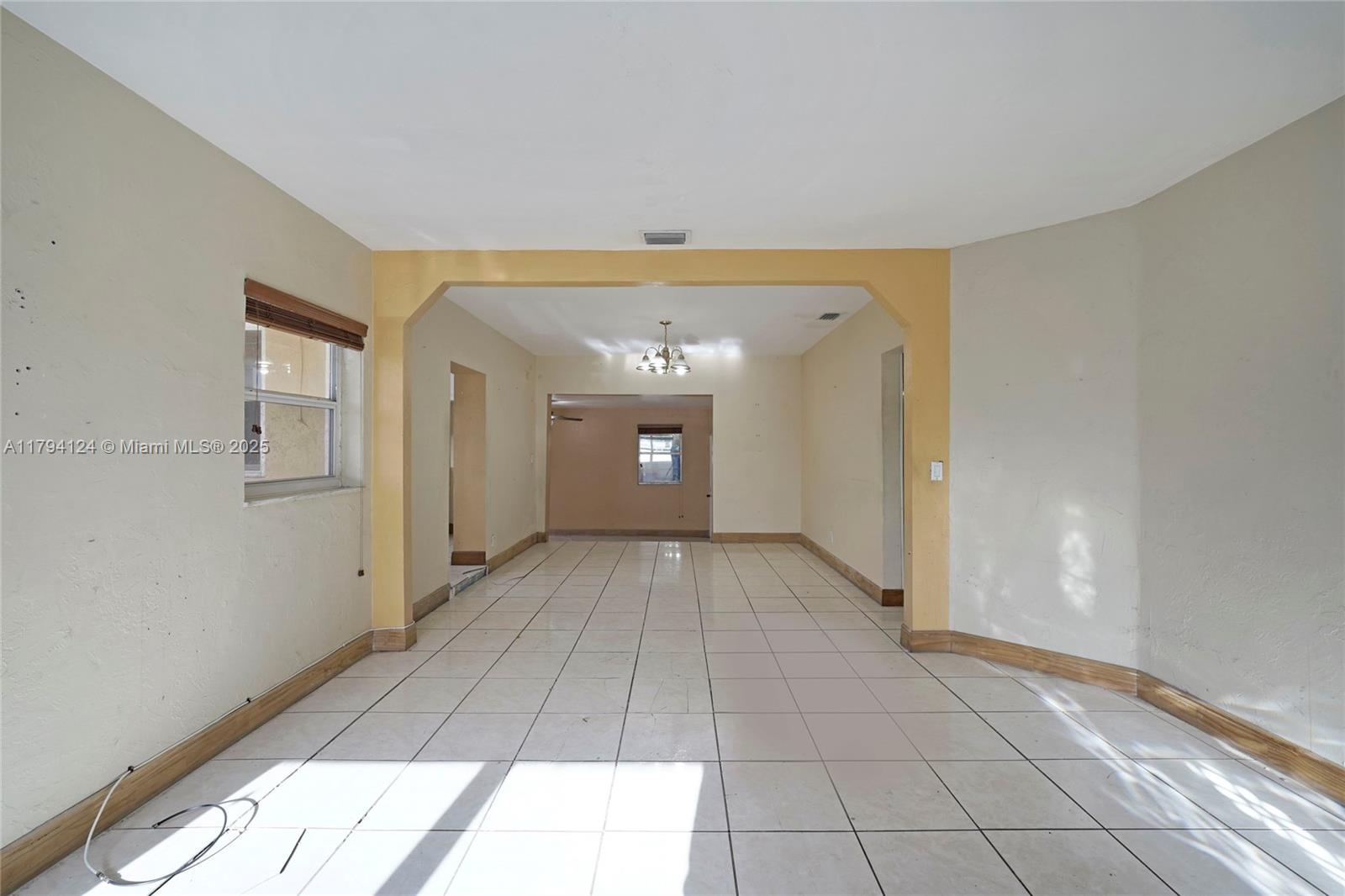 4241 West 1st Avenue Hialeah, FL 33012 - Photo 7 of 33 a view of a hallway with wooden floor and a living room