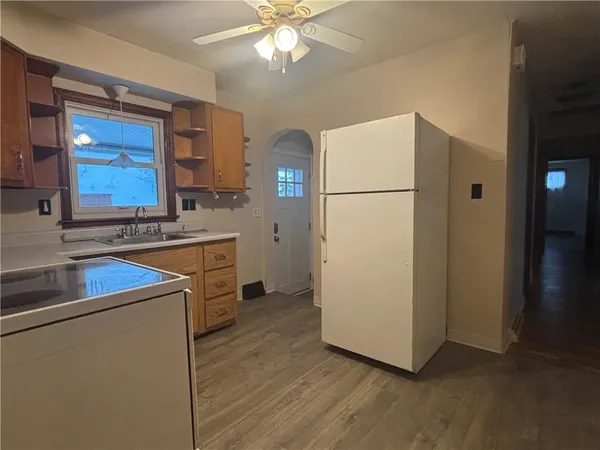 a kitchen with a refrigerator sink stove and cabinets