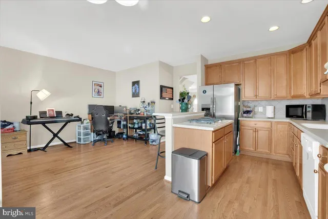 a kitchen with sink cabinets and wooden floor