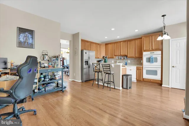 a dining room with furniture and wooden floor