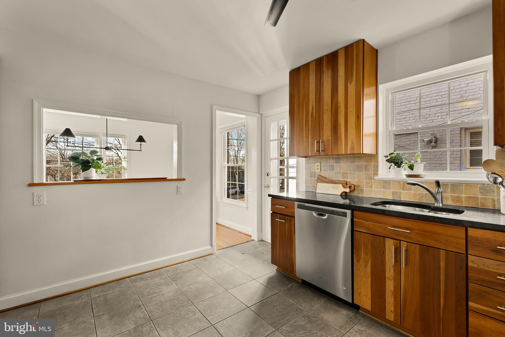 5705 MacArthur Boulevard Northwest Washington, DC 20016 - Photo 11 of 40 a kitchen with stainless steel appliances granite countertop a refrigerator sink and wooden cabinets