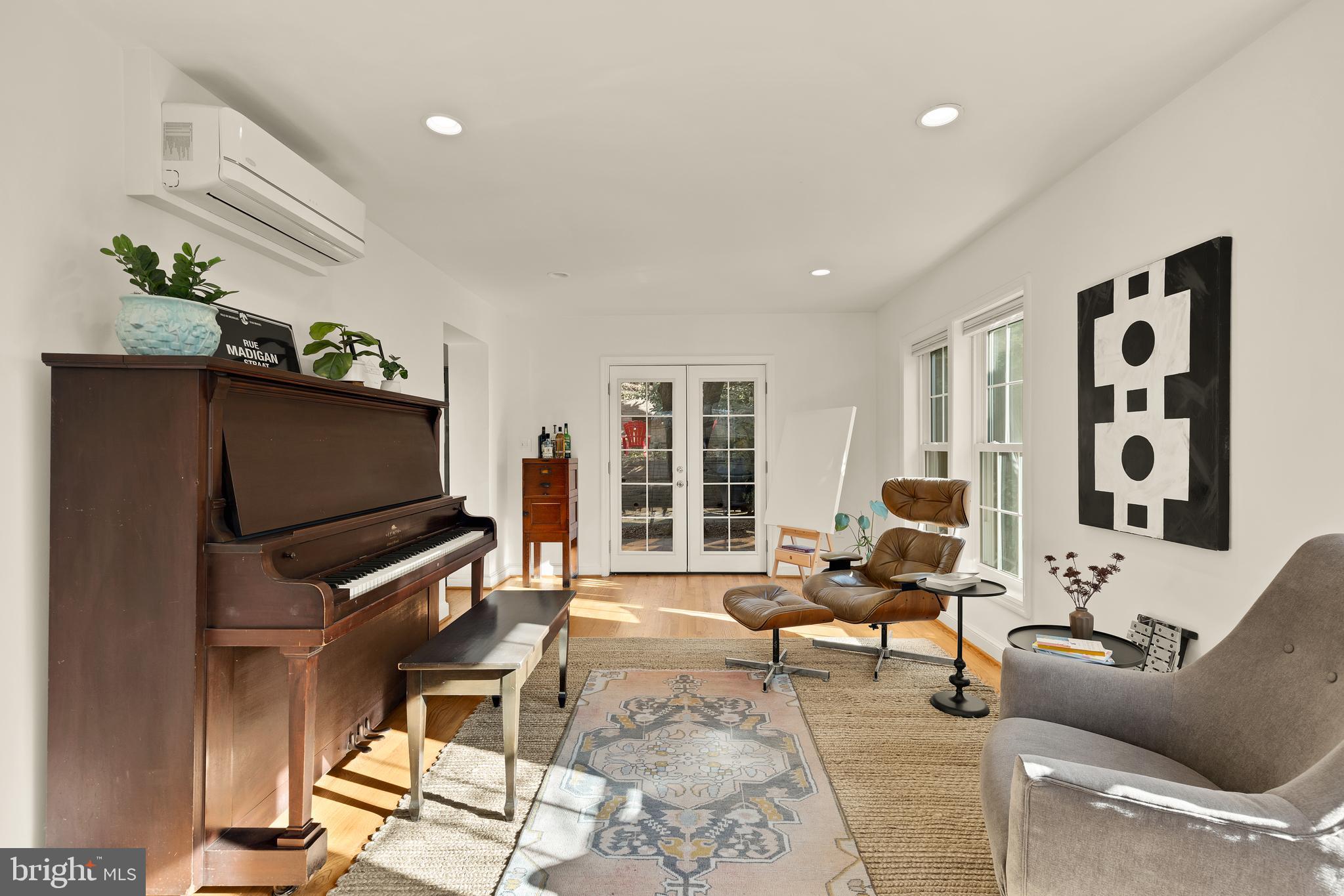 5705 MacArthur Boulevard Northwest Washington, DC 20016 - Photo 17 of 40 a living room with furniture a flat screen tv and a window