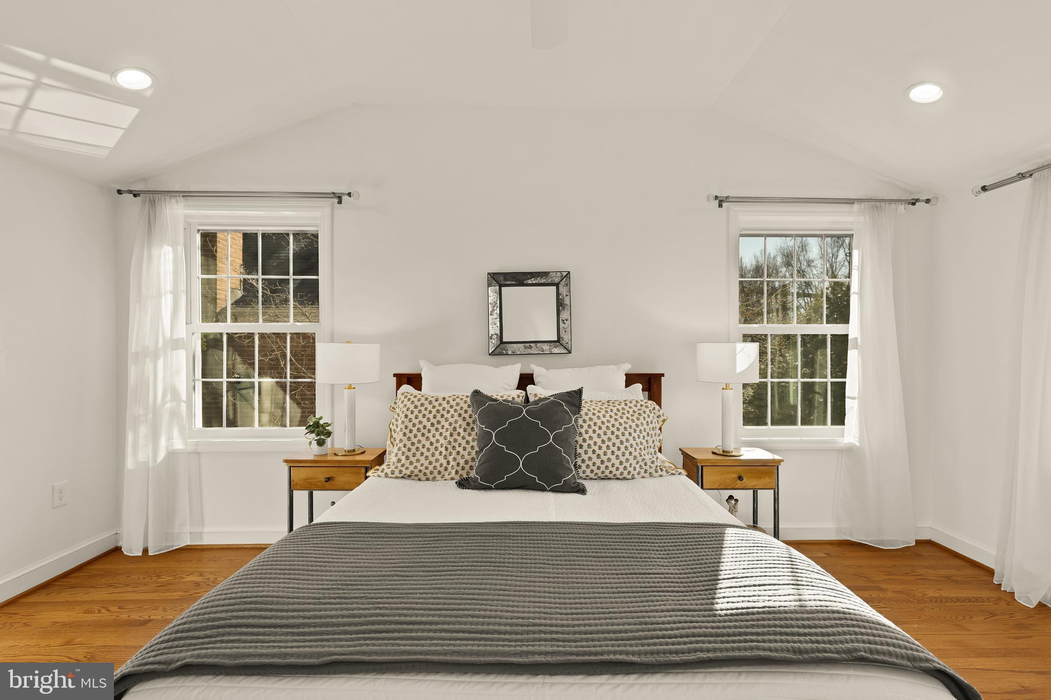5705 MacArthur Boulevard Northwest Washington, DC 20016 - Photo 18 of 40 a bedroom with a bed and wooden floor