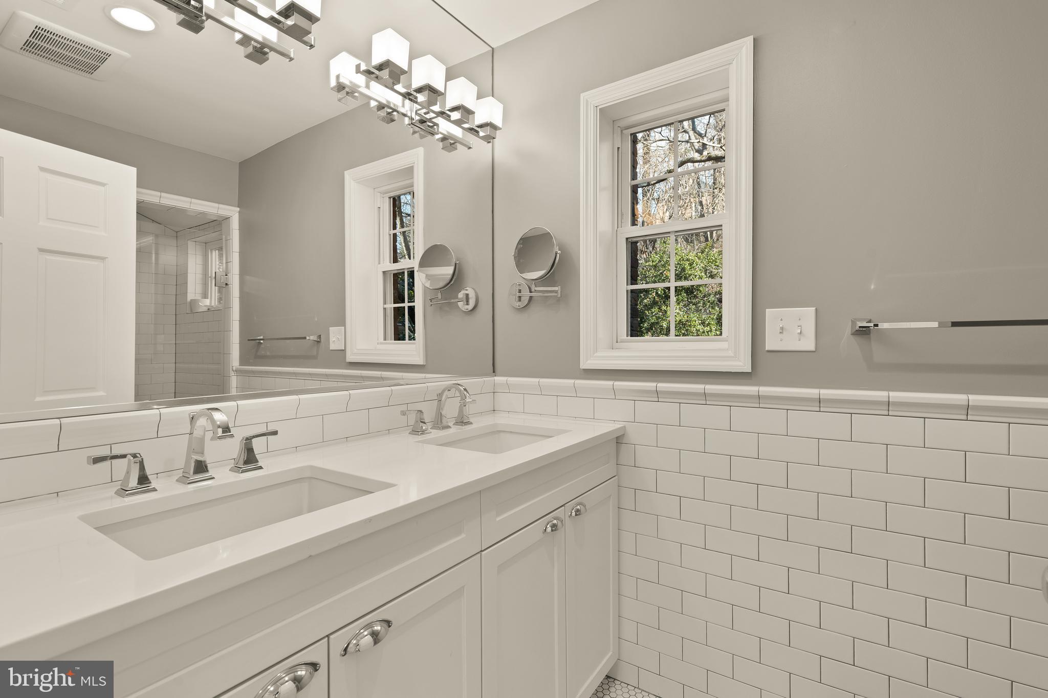 5705 MacArthur Boulevard Northwest Washington, DC 20016 - Photo 20 of 40 a bathroom with a sink a large mirror and a shower