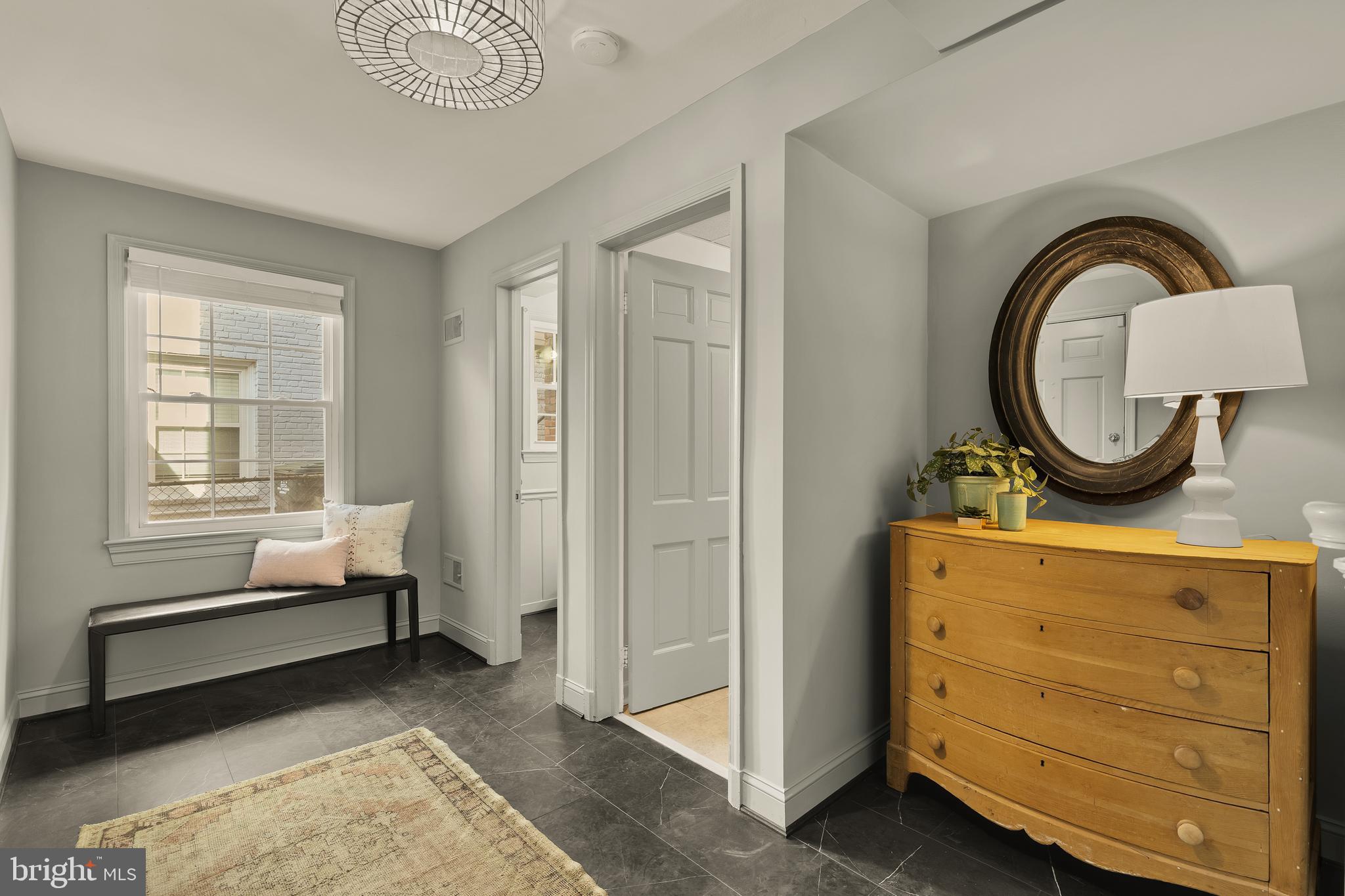 5705 MacArthur Boulevard Northwest Washington, DC 20016 - Photo 2 of 40 a bedroom with a bed and a mirror