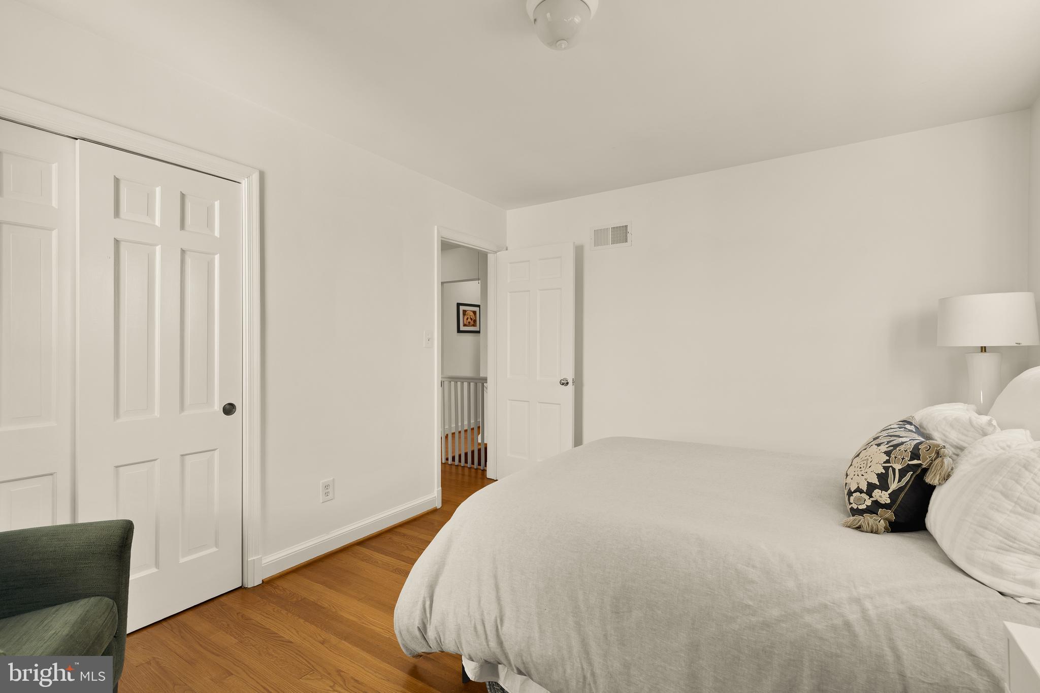5705 MacArthur Boulevard Northwest Washington, DC 20016 - Photo 23 of 40 a bedroom with a bed and wooden floor