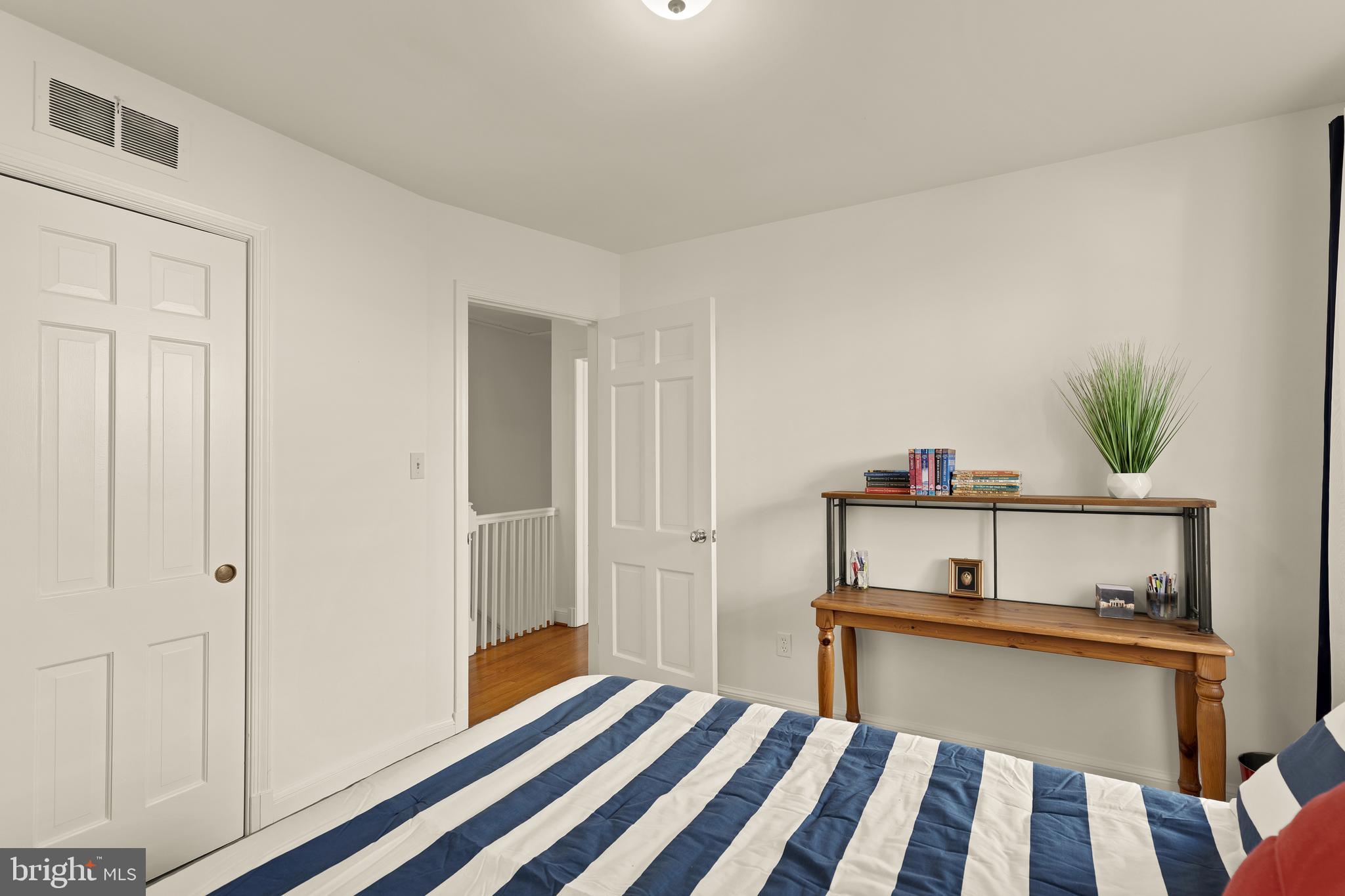 5705 MacArthur Boulevard Northwest Washington, DC 20016 - Photo 25 of 40 a bedroom with a bed and a potted plant