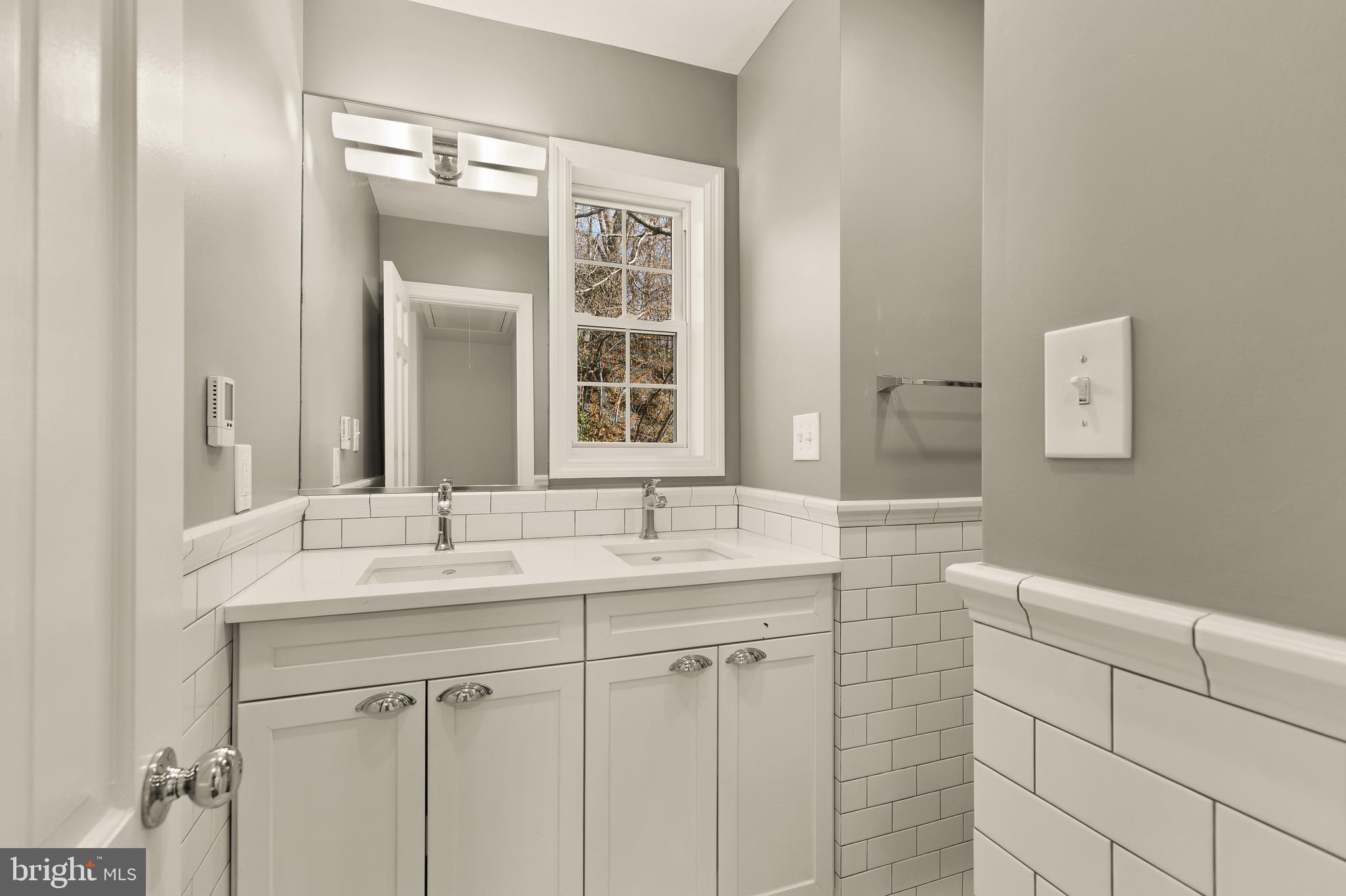 5705 MacArthur Boulevard Northwest Washington, DC 20016 - Photo 28 of 40 a bathroom with a sink and a mirror