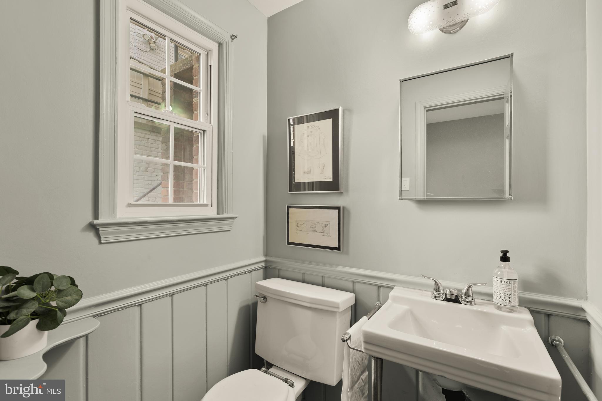 5705 MacArthur Boulevard Northwest Washington, DC 20016 - Photo 35 of 40 a bathroom with a sink mirror and toilet