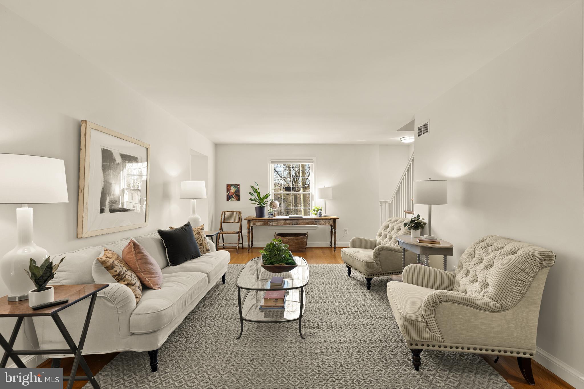 5705 MacArthur Boulevard Northwest Washington, DC 20016 - Photo 5 of 40 a living room with furniture and a lamp