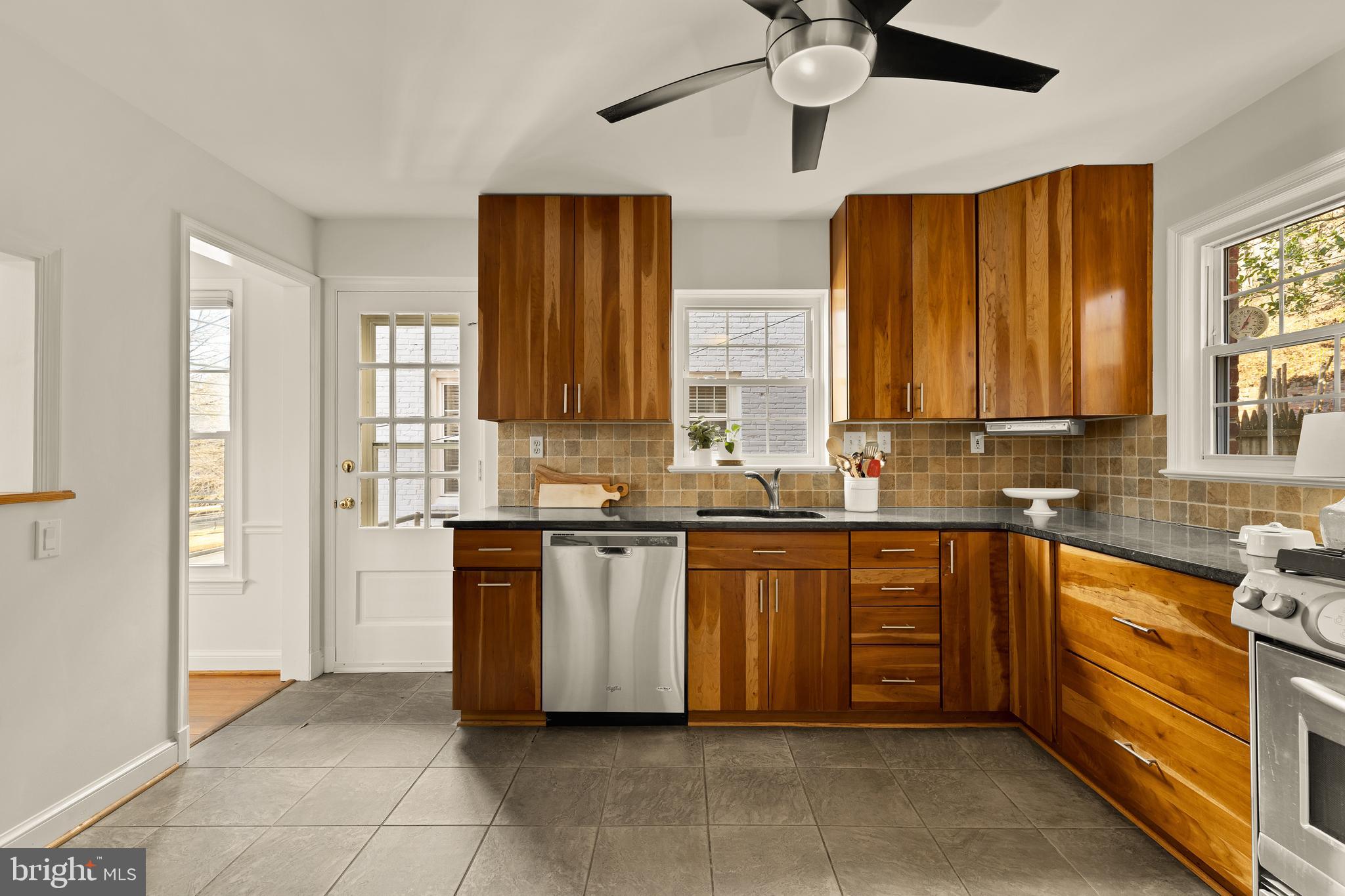 5705 MacArthur Boulevard Northwest Washington, DC 20016 - Photo 10 of 40 a large kitchen with stainless steel appliances granite countertop a refrigerator and a sink