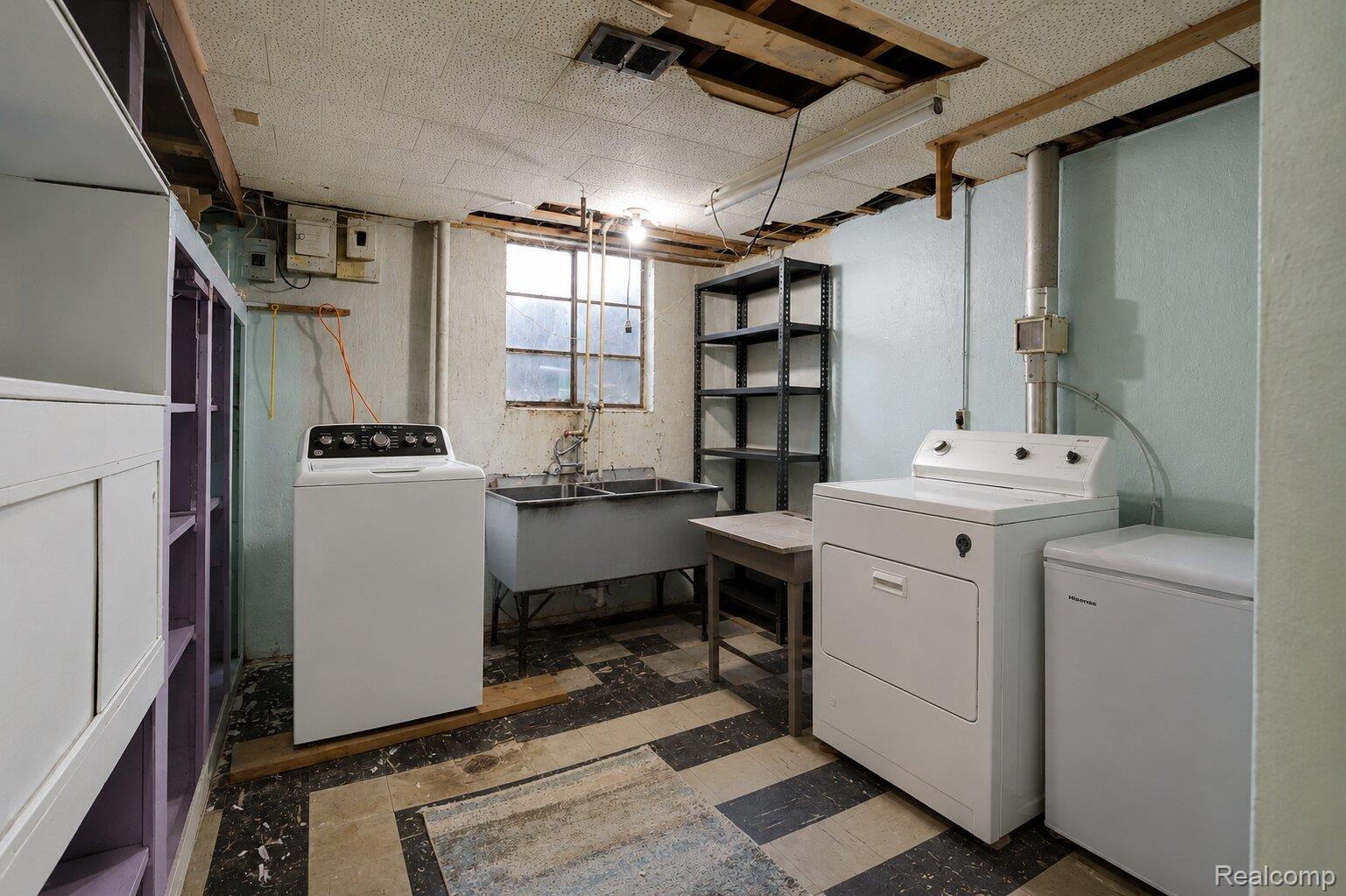 9101 Merriman Road Livonia, MI 48150 - Photo 21 of 24 Utility space featuring a double basin utility sink, checkered flooring, and a large window