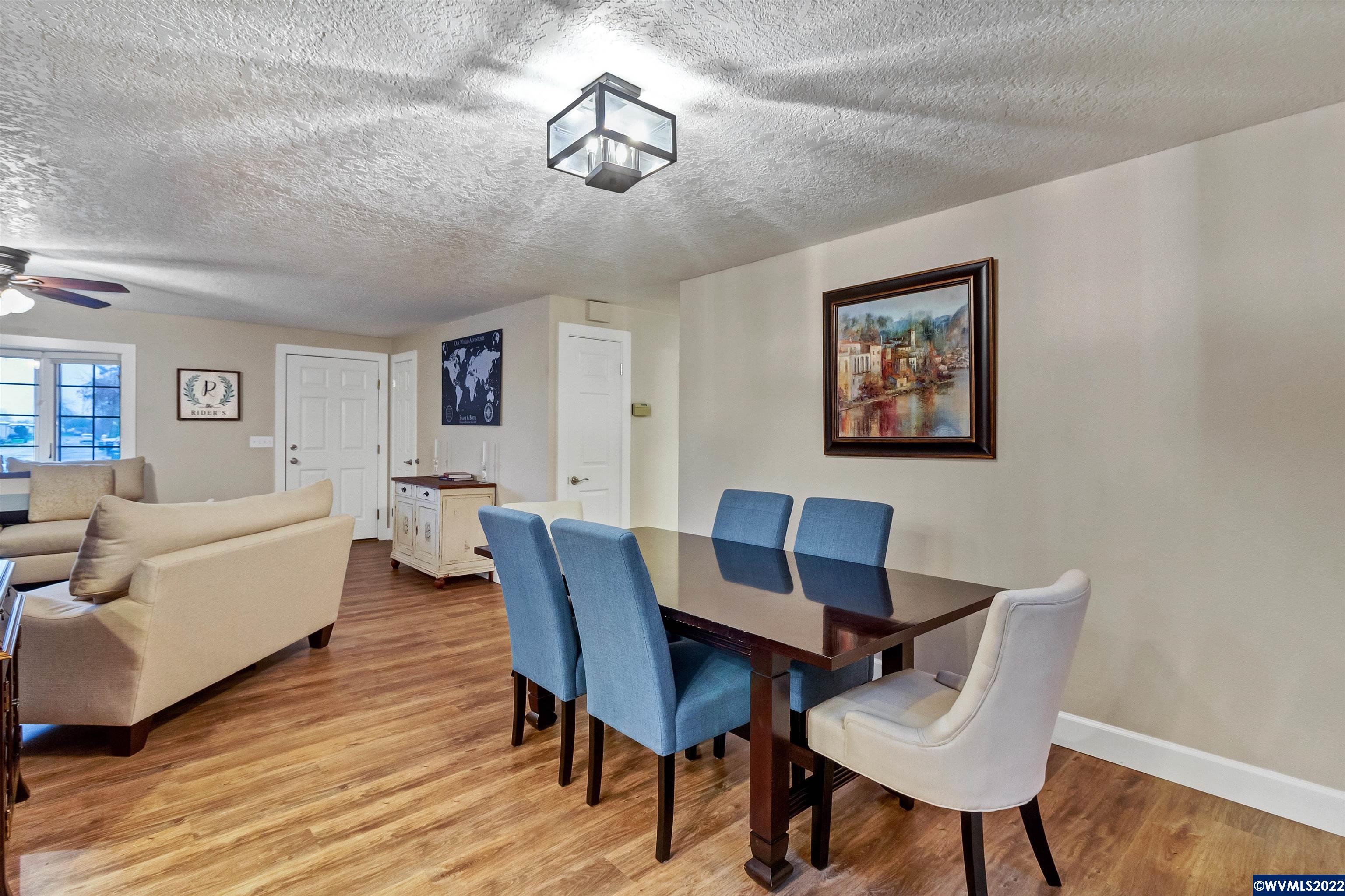 150 Edwards Road South Monmouth, OR 97361 - Photo 6 of 39 a view of a dining room with furniture a chandelier and wooden floor