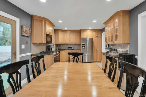 a kitchen with counter top space a sink appliances and cabinets