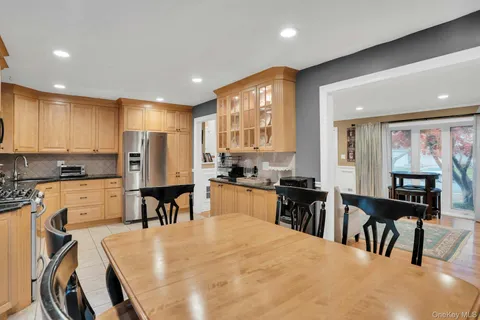 a kitchen with stainless steel appliances kitchen island granite top and refrigerator