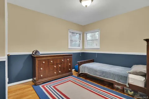 a living room with a bed and a dresser