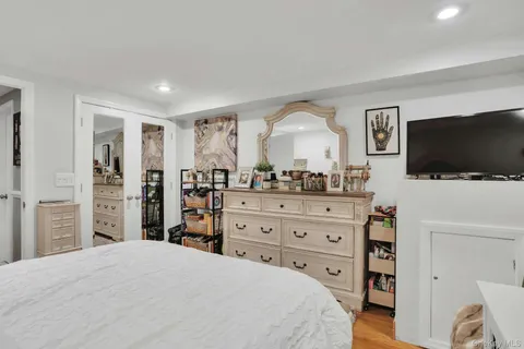 a bedroom with a bed and a flat screen tv