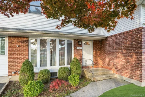 a view of a house with potted plants
