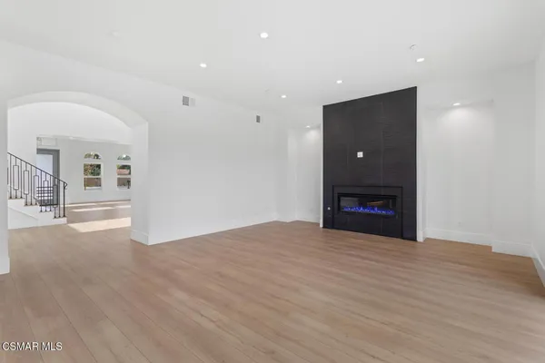 a view of a livingroom with furniture and book shelf