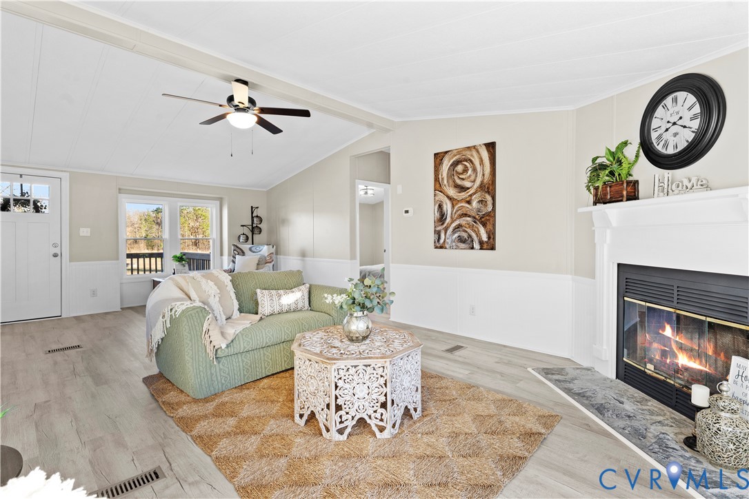 4621 Meherrin Road Meherrin, VA 23954 - Photo 11 of 49 a living room with furniture a clock and a fireplace