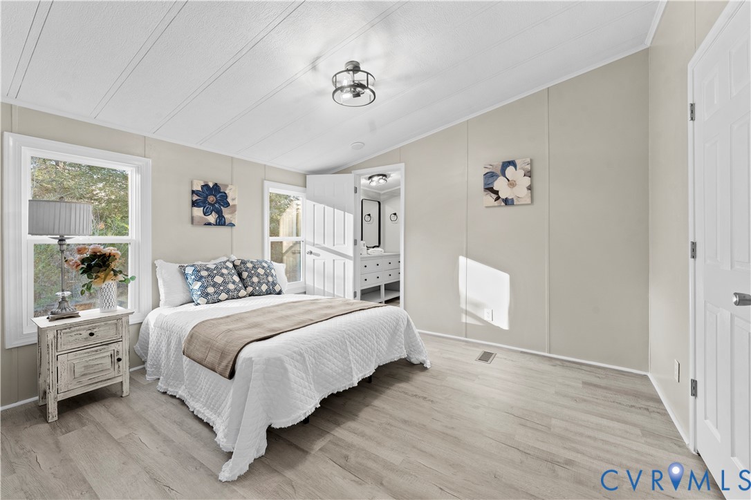 4621 Meherrin Road Meherrin, VA 23954 - Photo 12 of 49 a bedroom with a white bed and a chandelier