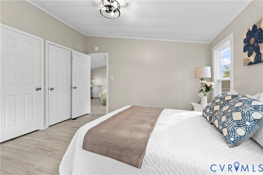 4621 Meherrin Road Meherrin, VA 23954 - Photo 14 of 49 a bedroom with a bed and a chandelier