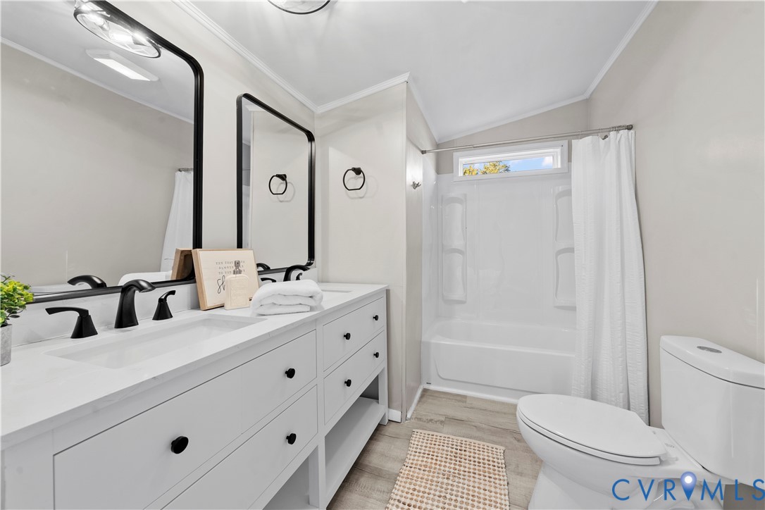 4621 Meherrin Road Meherrin, VA 23954 - Photo 15 of 49 a bathroom with a double vanity sink toilet mirror and shower