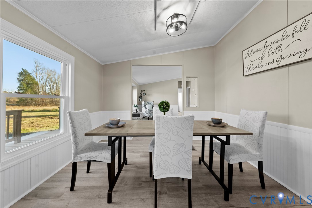 4621 Meherrin Road Meherrin, VA 23954 - Photo 17 of 49 a view of a dining room with furniture and wooden floor