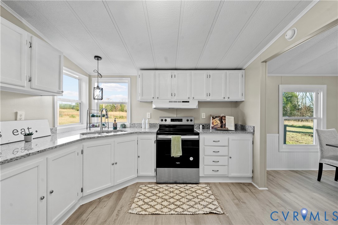 4621 Meherrin Road Meherrin, VA 23954 - Photo 20 of 49 a kitchen with granite countertop white cabinets and appliances